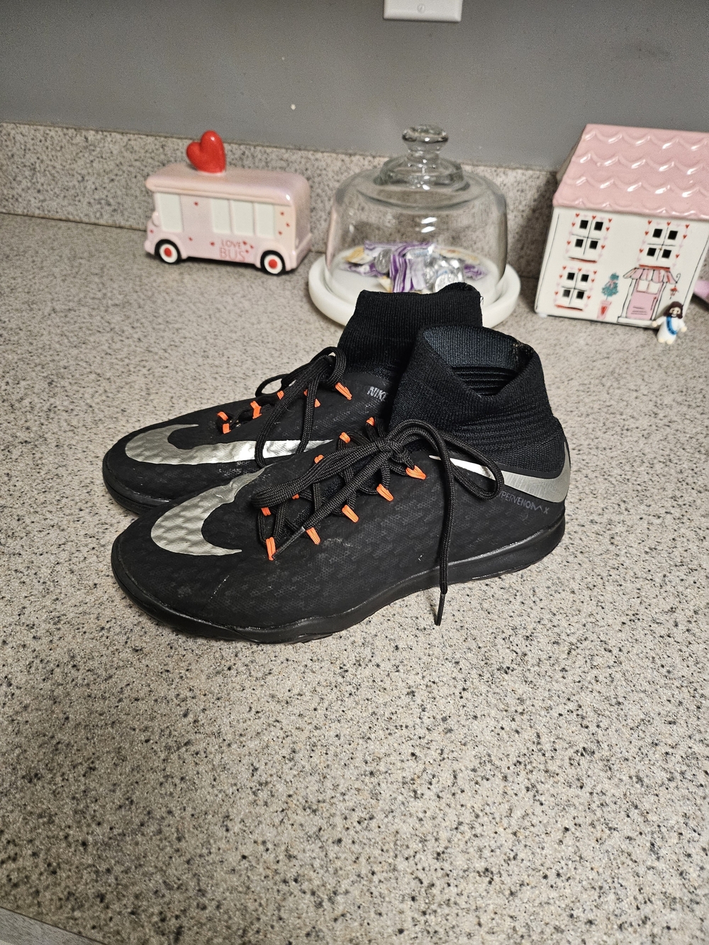 Nike Black Kids Indoor Soccer Shoes with Silver Swoosh and Orange Lace Tabs
